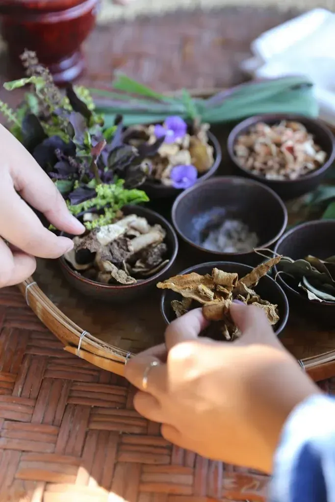 Hands making a Thai herbal inhaler